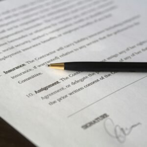 Close-up image of a business contract and pen, signed and ready for agreement.