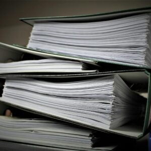 Close-up of stacked binders filled with documents for office or educational use.